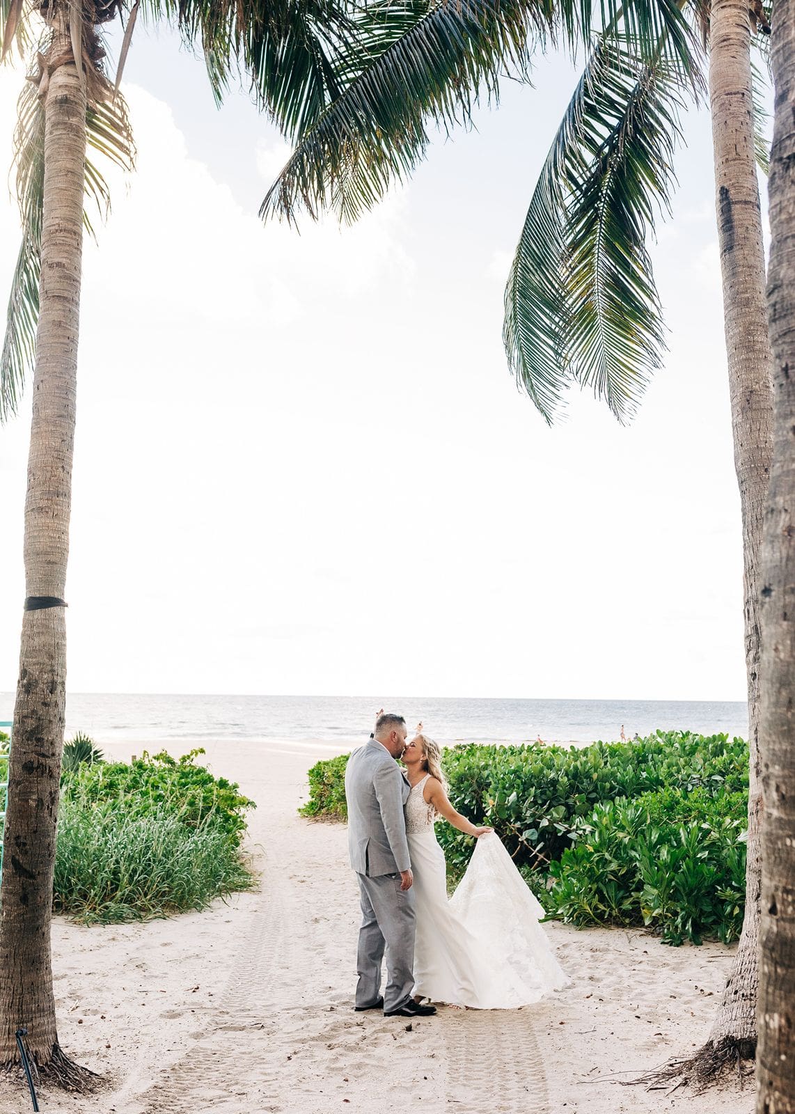 Wedding portraits under palm trees in the bahamas