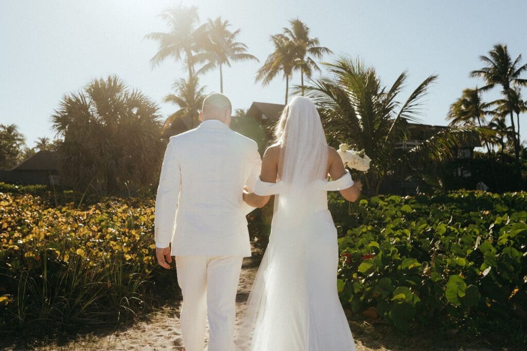 Couple leaving beach wedding ceremony in the Bahamas